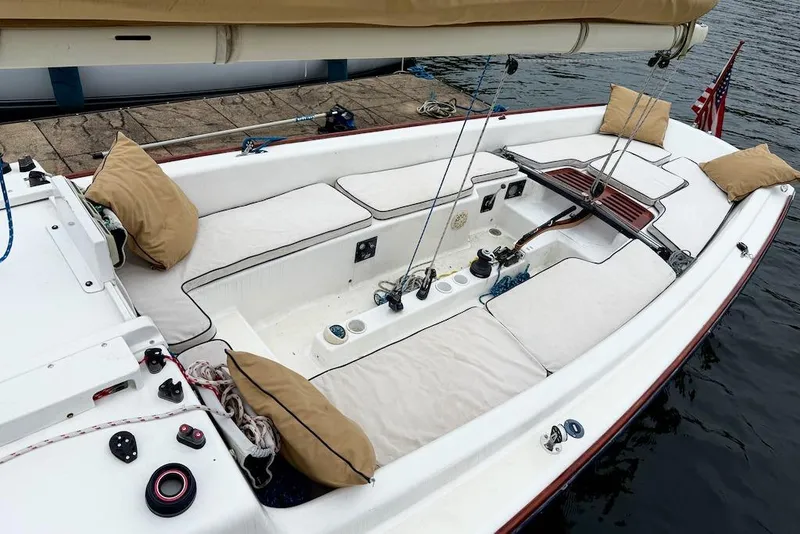 Slide: The Image of 2008 e Sailing Yachts e33 sailboat cockpit with cushions and rigging, docked by the water. - 5