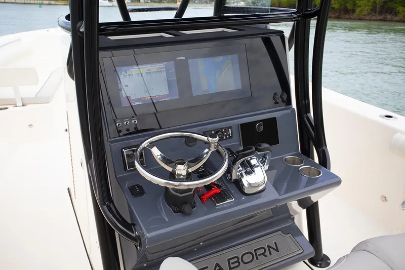 Slide: The Image of 2023 Sea Born LX26 Center Console boat with seating and storage, docked outdoors. - 5