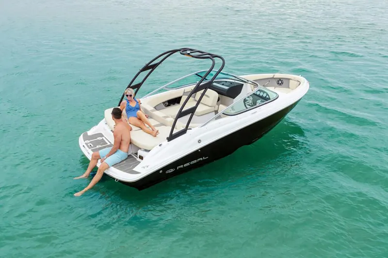 Slide: The Image of Manufacturer Provided Image: 2026 Regal 2000 ES boat with two people relaxing on turquoise water. - 2
