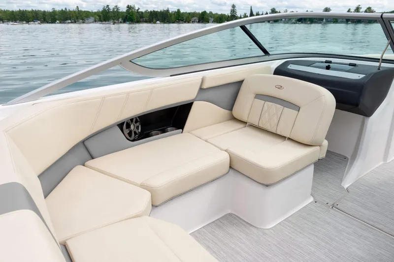 Slide: The Image of Manufacturer Provided Image: 2026 Regal 2000 ES boat interior with beige seating on a calm lake. - 5