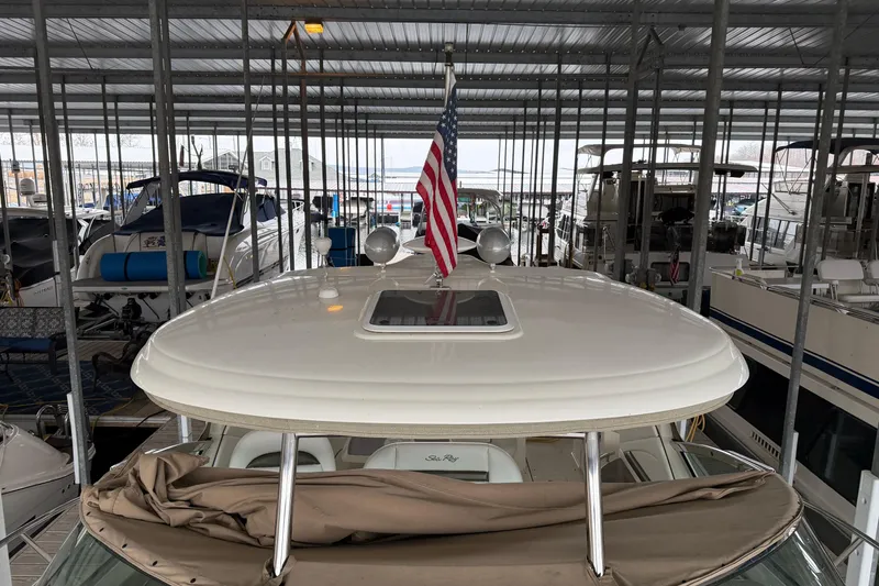 Slide: The Image of 2006 Sea Ray 40 Sundancer docked in marina with American flag displayed. - 10