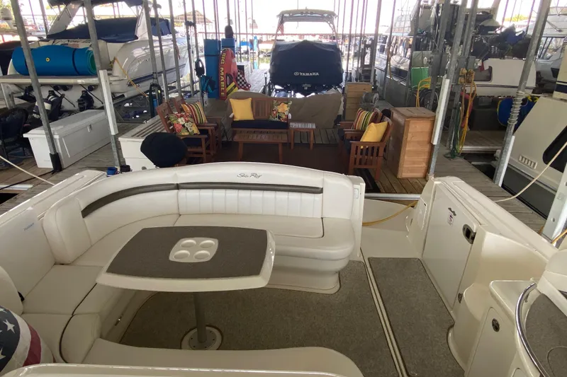 Slide: The Image of 2006 Sea Ray 40 Sundancer yacht interior with seating and table in a marina setting. - 13