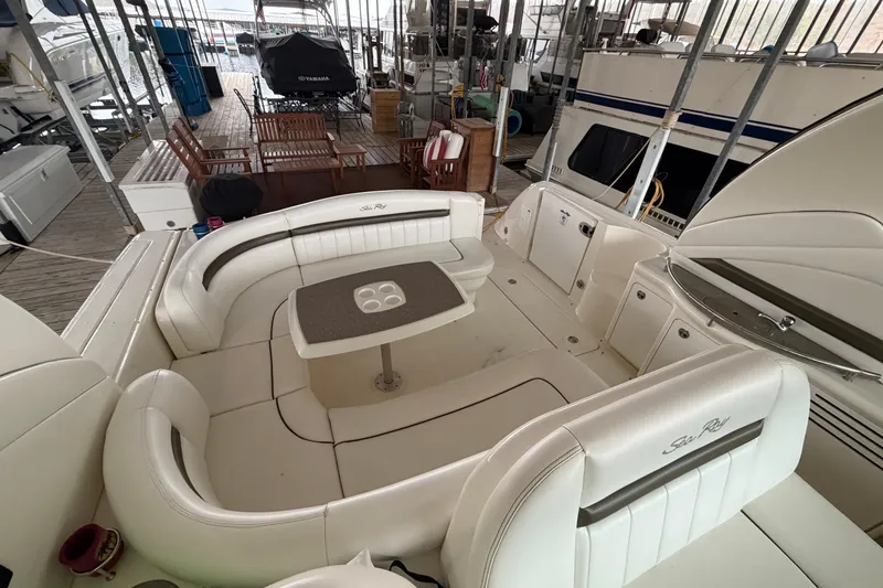 Slide: The Image of 2006 Sea Ray 40 Sundancer yacht interior with white seating and table in marina. - 15