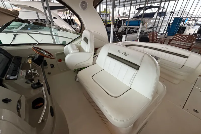 Slide: The Image of 2006 Sea Ray 40 Sundancer cockpit with white leather seating and steering wheel. - 19