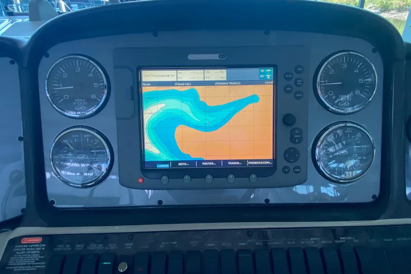 Slide: The Image of Dashboard of a 2006 Sea Ray 40 Sundancer with navigation display and gauges. - 22