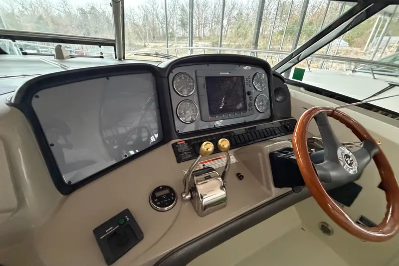 Slide: The Image of 2006 Sea Ray 40 Sundancer helm with steering wheel, gauges, and navigation system. - 23