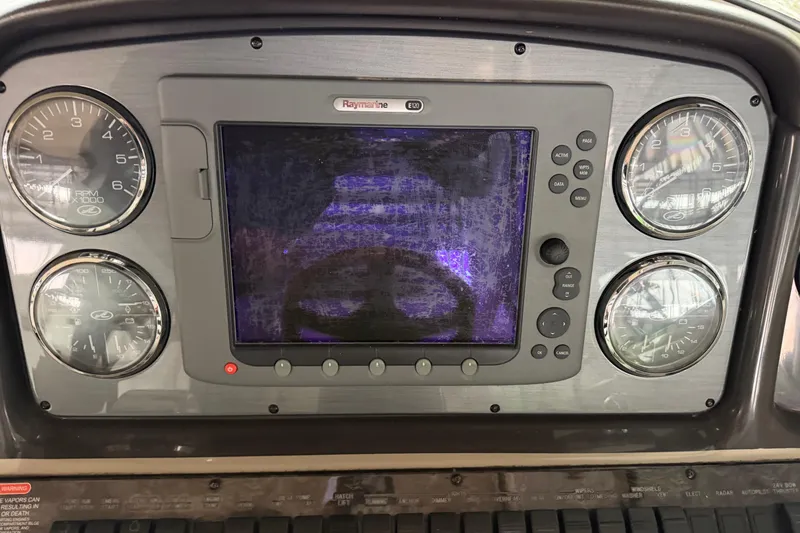 Slide: The Image of Dashboard of 2006 Sea Ray 40 Sundancer with gauges and Raymarine display. - 25