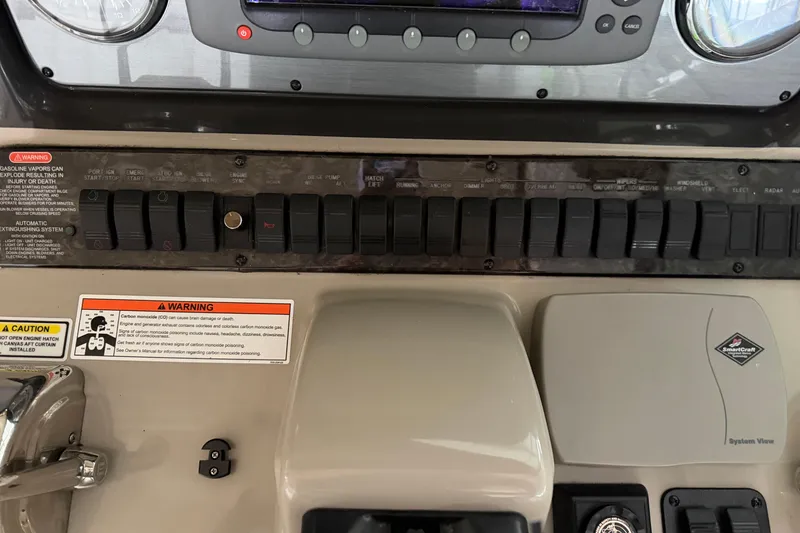 Slide: The Image of Control panel of a 2006 Sea Ray 40 Sundancer boat with warning labels. - 27