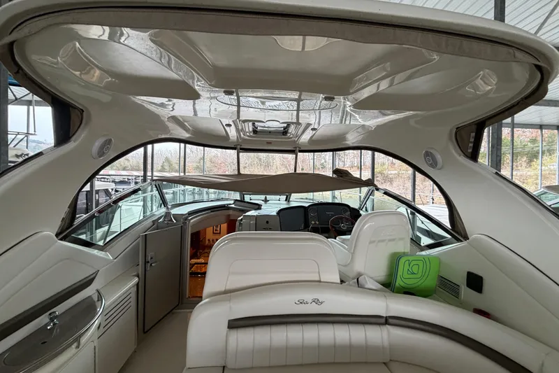 Slide: The Image of Interior view of 2006 Sea Ray 40 Sundancer yacht, featuring luxurious seating and helm. - 29