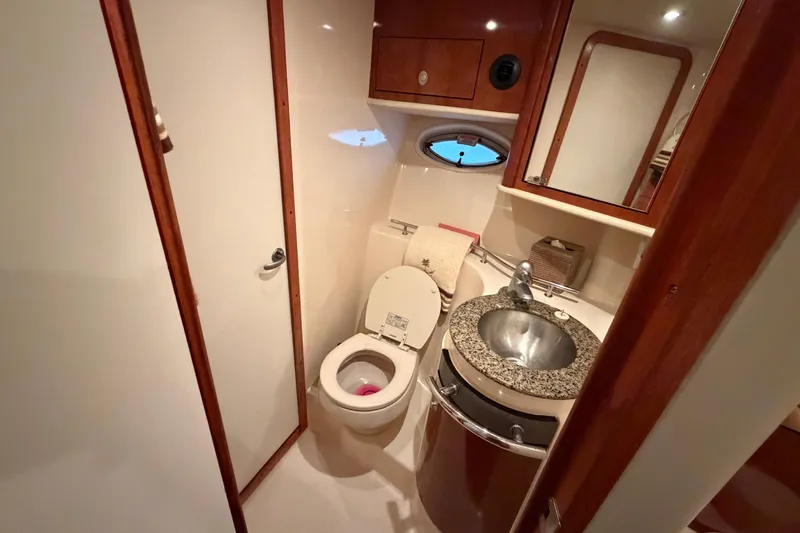 Slide: The Image of 2006 Sea Ray 40 Sundancer bathroom with granite sink and modern fixtures. - 38