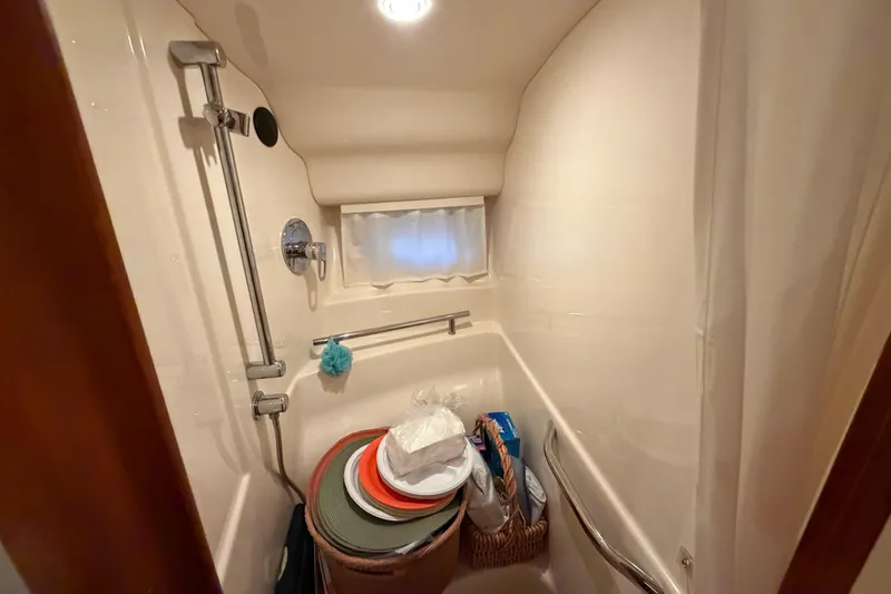 Slide: The Image of Shower area in 2006 Sea Ray 40 Sundancer yacht with storage items. - 39