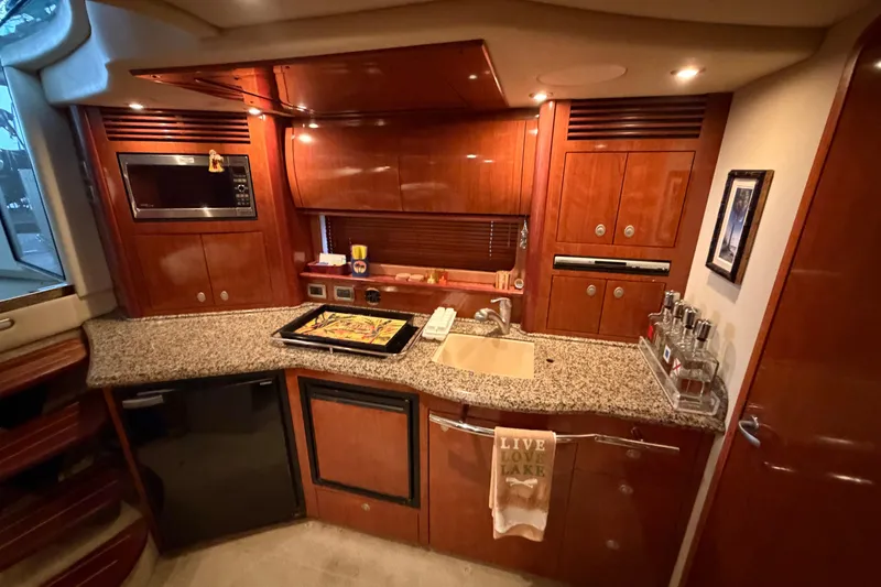 Slide: The Image of Luxurious 2006 Sea Ray 40 Sundancer yacht kitchen with granite countertops and wood cabinetry. - 40