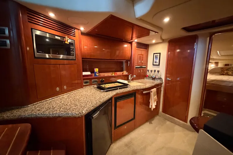 Slide: The Image of Luxurious 2006 Sea Ray 40 Sundancer yacht interior with modern kitchen amenities. - 41
