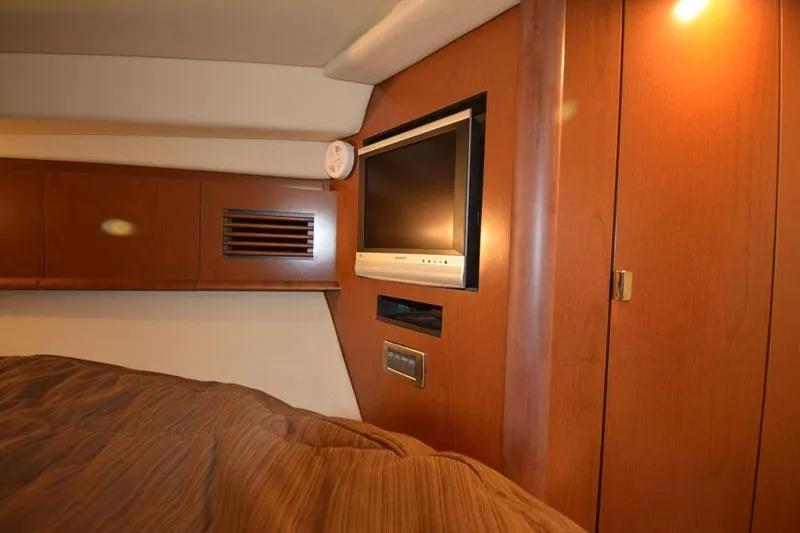 Slide: The Image of 2006 Sea Ray 40 Sundancer cabin interior with TV and wood paneling. - 43