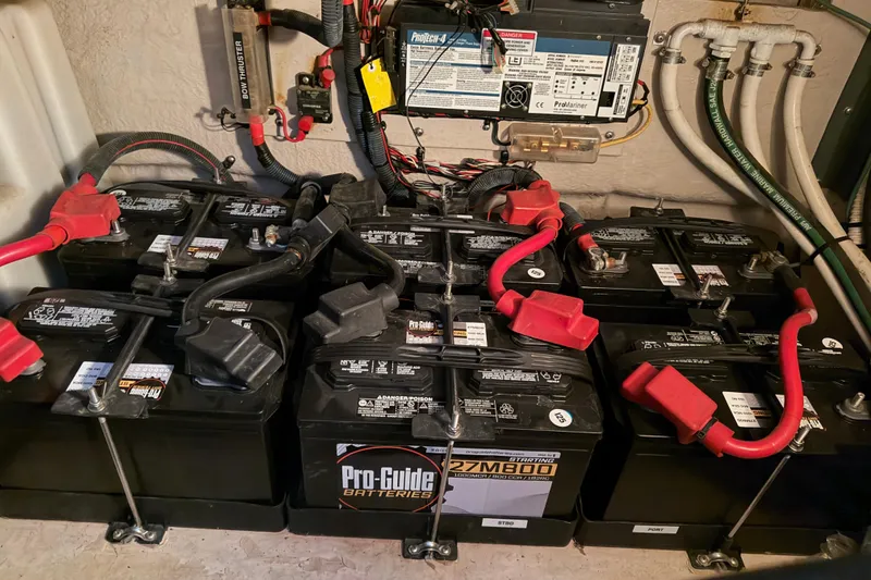 Slide: The Image of Battery setup in a 2006 Sea Ray 40 Sundancer boat engine compartment. - 44