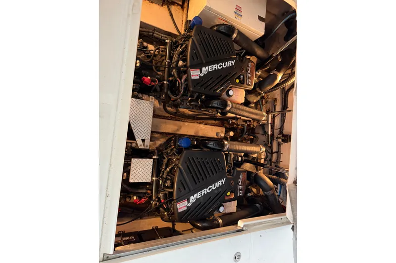 Slide: The Image of Engine compartment of 2006 Sea Ray 40 Sundancer with twin Mercury engines. - 48