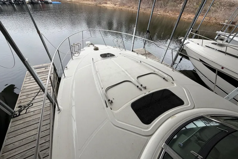 Slide: The Image of 2006 Sea Ray 40 Sundancer yacht docked at a marina, viewed from the bow. - 6