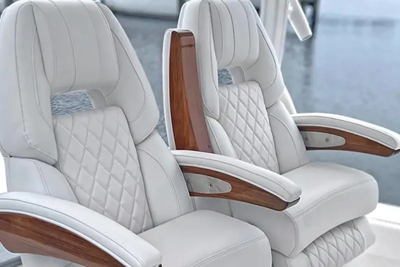 Slide: The Image of Luxurious white leather seats with wooden armrests on 2026 Regulator 30XO boat. - 4