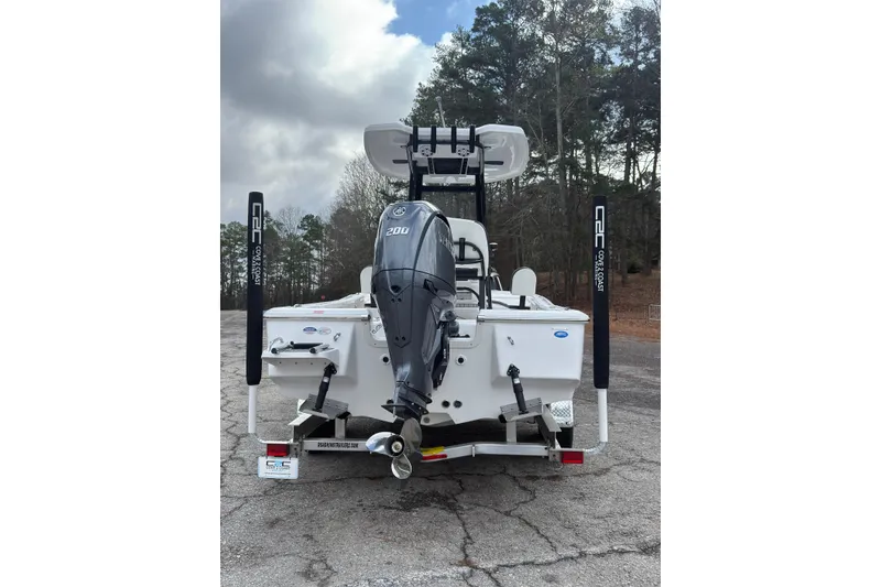 Slide: The Image of 2026 Tidewater 2210 Carolina Bay boat with Yamaha 200 engine, parked on a trailer. - 1