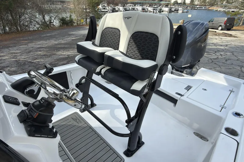Slide: The Image of 2026 Tidewater 2210 Carolina Bay boat interior with dual seats and steering wheel. - 11