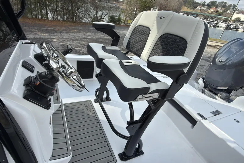 Slide: The Image of 2026 Tidewater 2210 Carolina Bay boat interior with steering wheel and seating. - 12