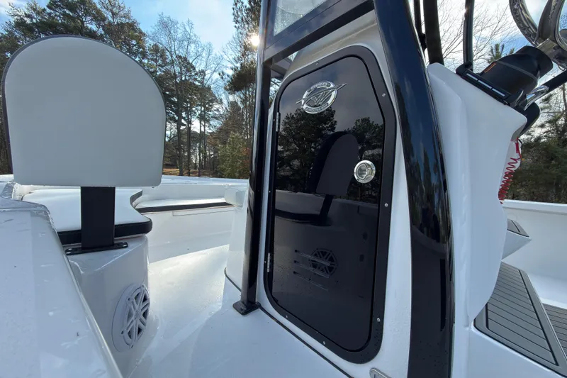 Slide: The Image of 2026 Tidewater 2210 Carolina Bay boat interior with seating and console details. - 14
