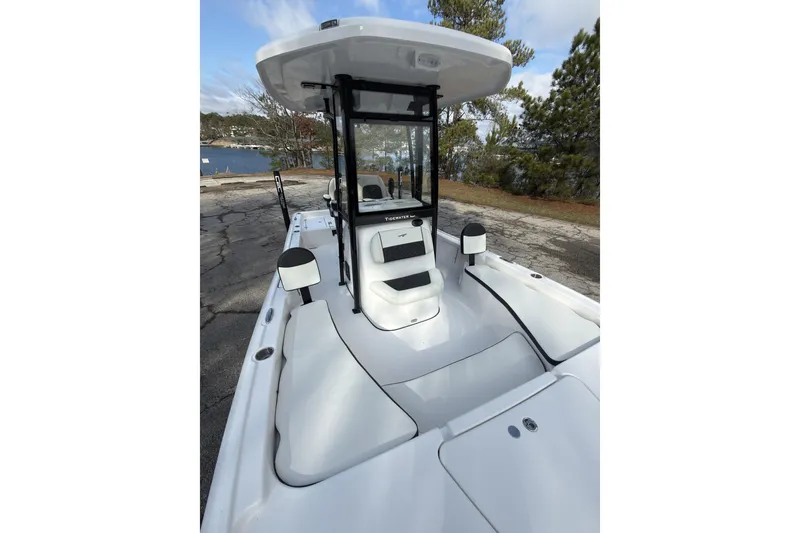 Slide: The Image of 2026 Tidewater 2210 Carolina Bay boat with sleek design, docked near a scenic waterfront. - 15