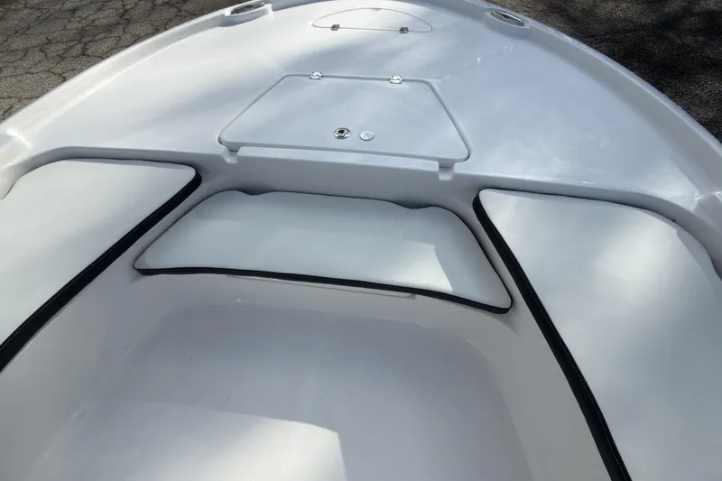 Slide: The Image of 2026 Tidewater 2210 Carolina Bay boat interior with cushioned seating and storage compartment. - 17