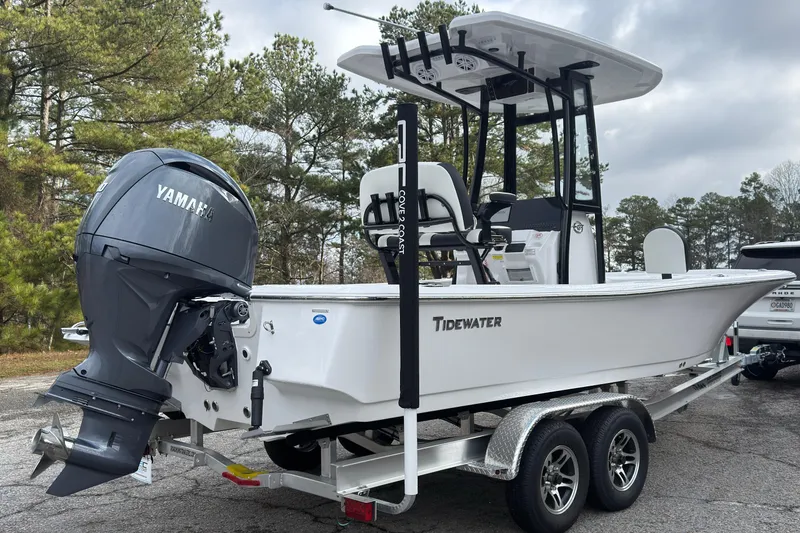 Slide: The Image of 2026 Tidewater 2210 Carolina Bay boat with Yamaha engine on trailer, parked outdoors. - 2