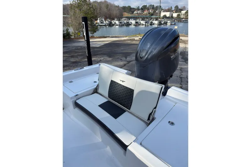 Slide: The Image of 2026 Tidewater 2210 Carolina Bay boat with seating and outboard motor by a marina. - 20