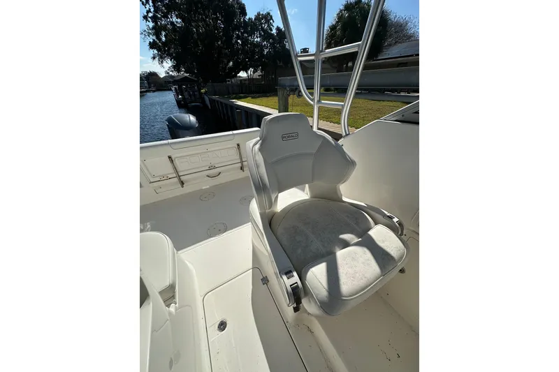 Slide: The Image of 2011 Robalo R245 Walkaround boat interior with seating and water view. - 9