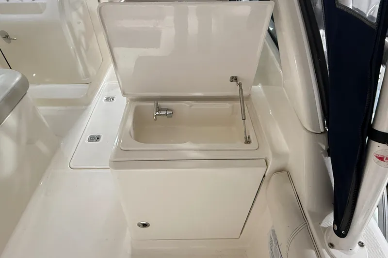 Slide: The Image of Yamaha four-stroke engine on 2014 Pursuit DC 265 Dual Console boat in storage facility. - 10