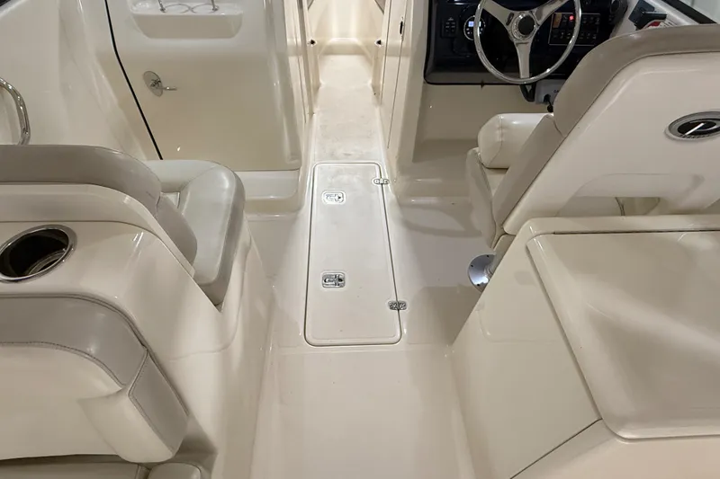 Slide: The Image of 2014 Pursuit DC 265 Dual Console boat propeller in a garage setting. - 11