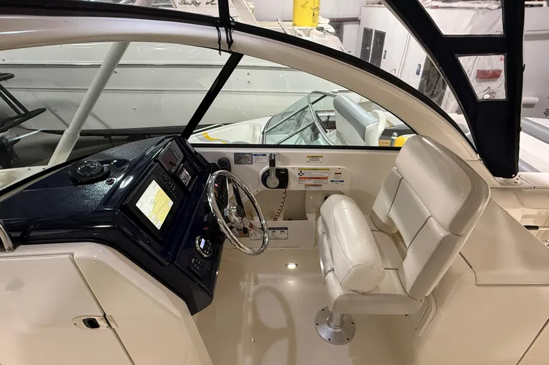 Slide: The Image of 2014 Pursuit DC 265 Dual Console boat interior with seating and nautical decor. - 13