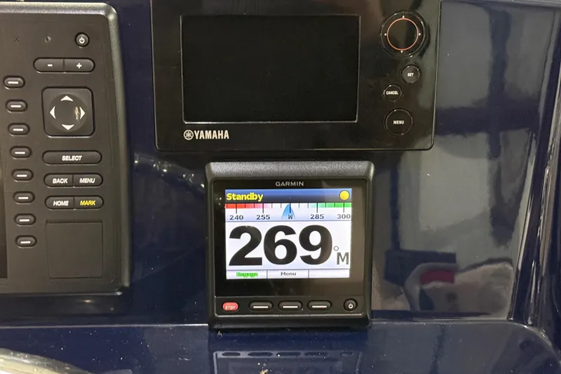 Slide: The Image of 2014 Pursuit DC 265 Dual Console boat interior with seating and Mercury outboard engines. - 17