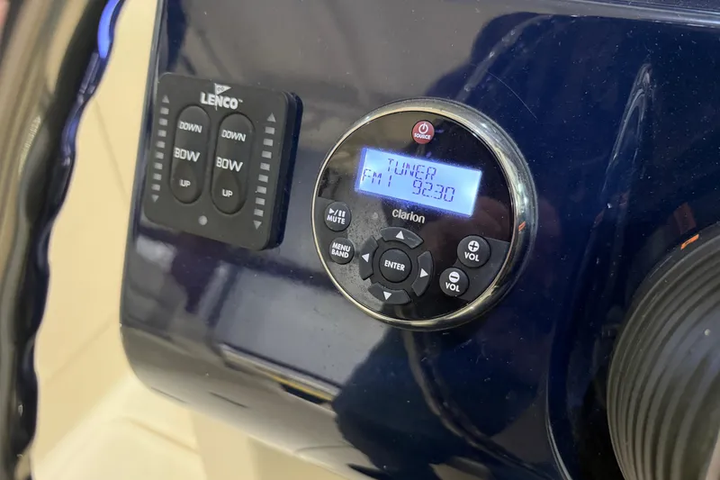 Slide: The Image of Open storage compartment on 2014 Pursuit DC 265 Dual Console boat. - 18