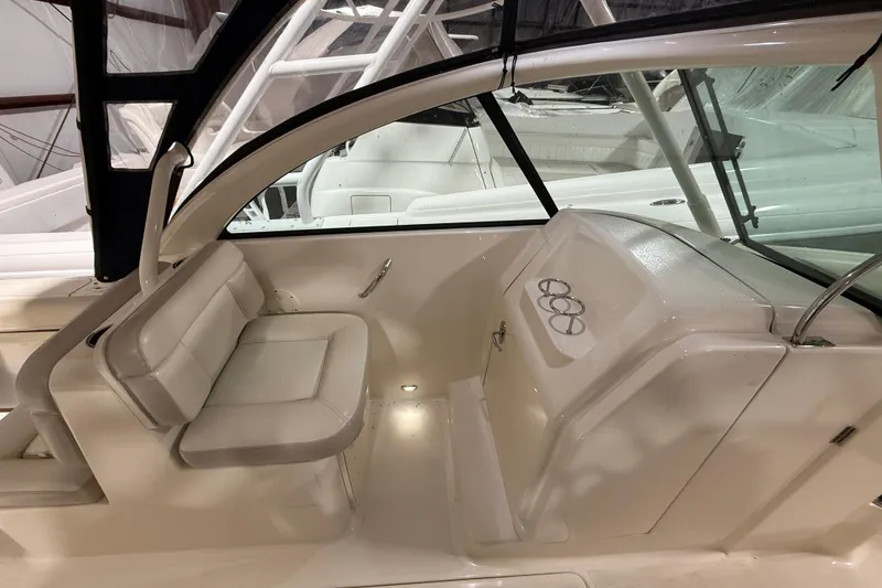 Slide: The Image of 2014 Pursuit DC 265 Dual Console boat storage compartments and latch detail. - 19