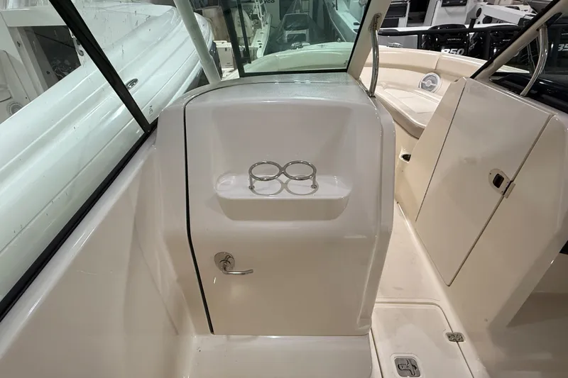 Slide: The Image of 2014 Pursuit DC 265 Dual Console boat interior with seating and helm. - 21
