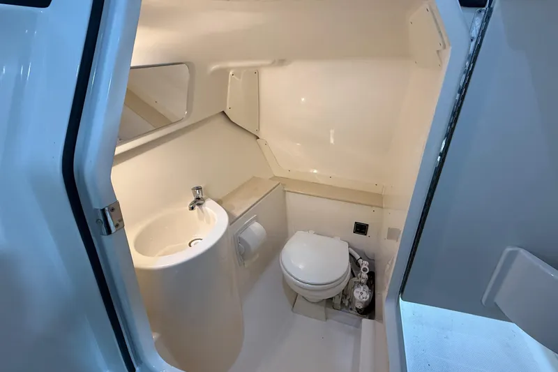 Slide: The Image of 2014 Pursuit DC 265 Dual Console boat interior with beige seating and modern design. - 22