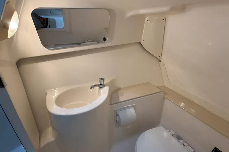 Slide: The Image of 2014 Pursuit DC 265 Dual Console boat interior with rod holders and speaker. - 24