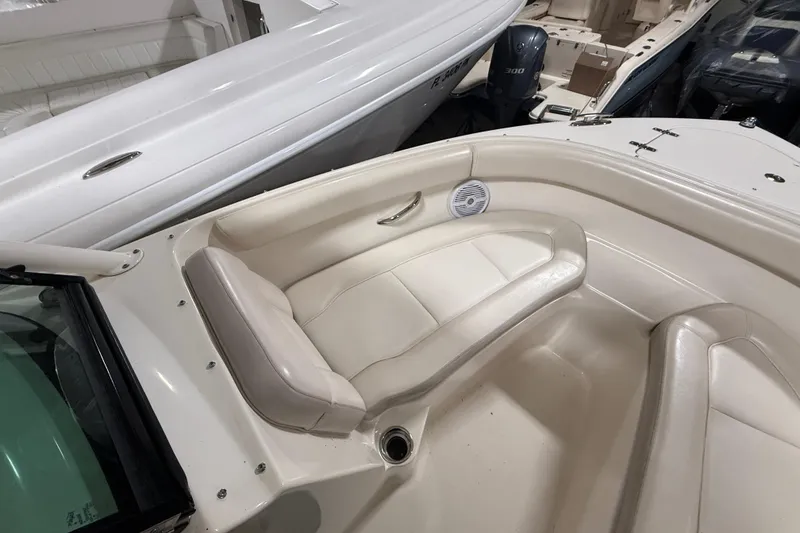 Slide: The Image of 2014 Pursuit DC 265 Dual Console boat fresh water tap and storage compartment. - 26