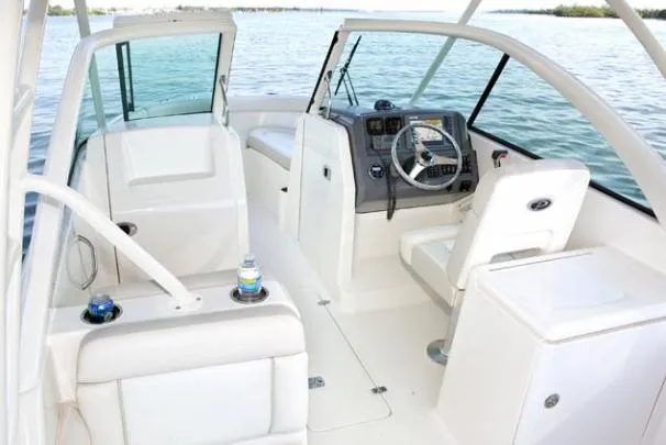 Slide: The Image of 2014 Pursuit DC 265 Dual Console boat interior with open storage drawers under seat. - 36