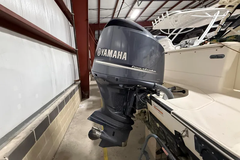 Slide: The Image of 2014 Pursuit DC 265 Dual Console boat in indoor storage facility. - 4