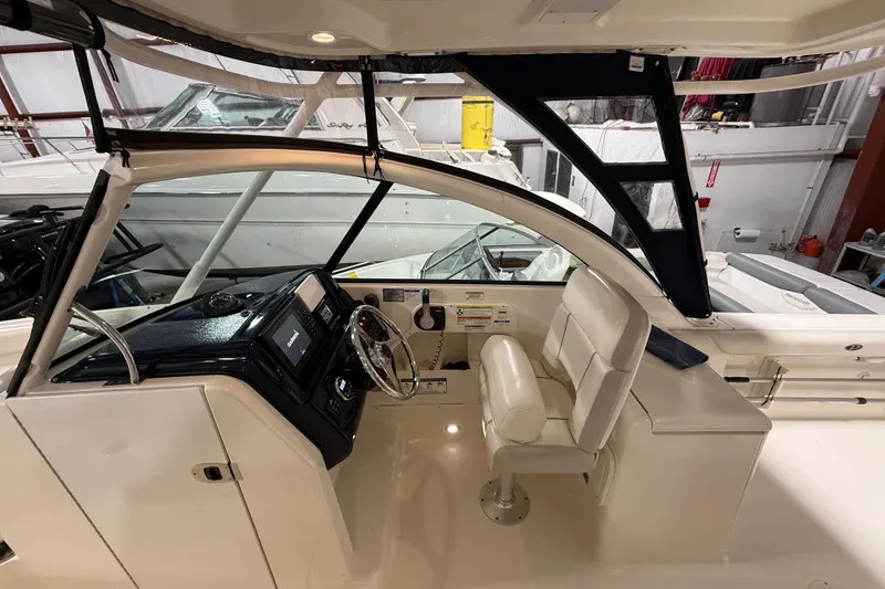 Slide: The Image of 2014 Pursuit DC 265 Dual Console boat interior with helm and seating. - 41