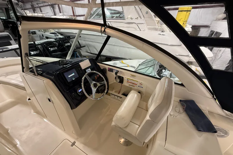 Slide: The Image of 2014 Pursuit DC 265 Dual Console boat interior with steering wheel and navigation system. - 42