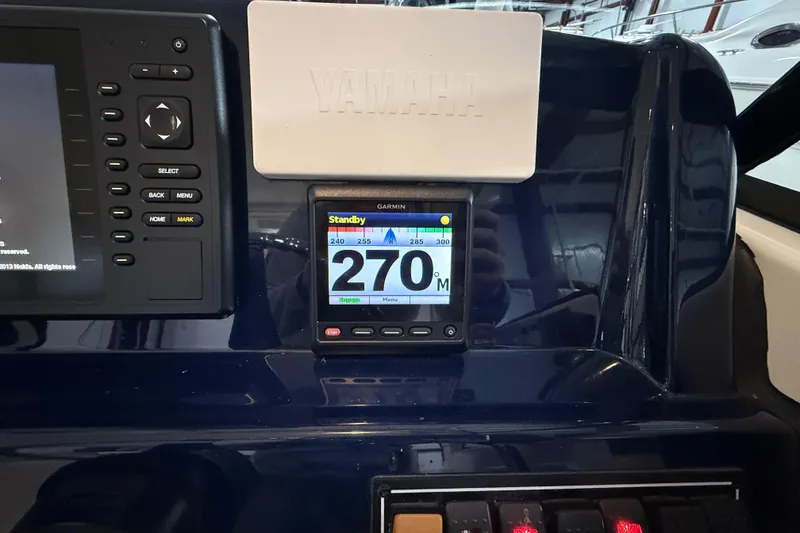 Slide: The Image of Dashboard of a 2014 Pursuit DC 265 Dual Console with Garmin display and Yamaha panel. - 45