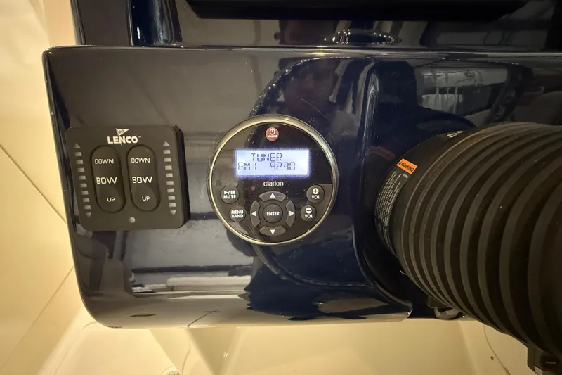 Slide: The Image of Control panel of a 2014 Pursuit DC 265 Dual Console boat with Lenco and Clarion systems. - 47