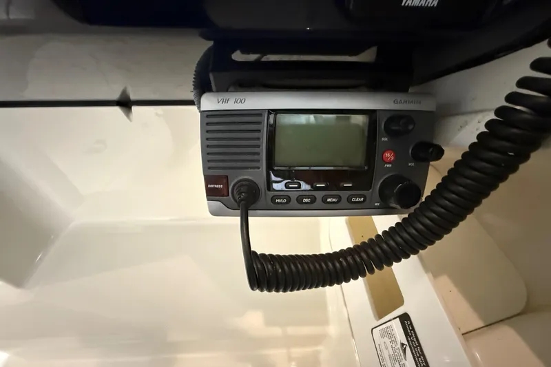 Slide: The Image of VHF radio on 2014 Pursuit DC 265 Dual Console boat dashboard. - 48