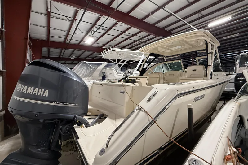 Slide: The Image of 2014 Pursuit DC 265 Dual Console boat in indoor storage facility. - 5