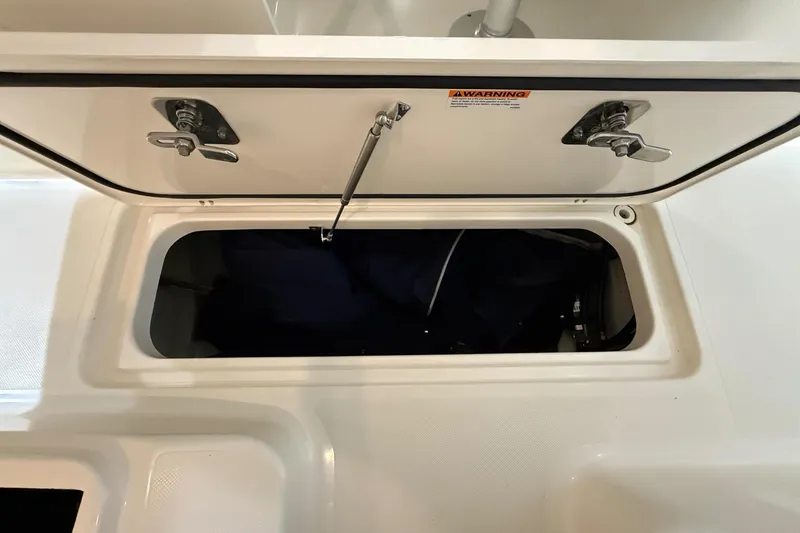 Slide: The Image of Open storage compartment on a Pursuit DC 265 Dual Console boat. - 51
